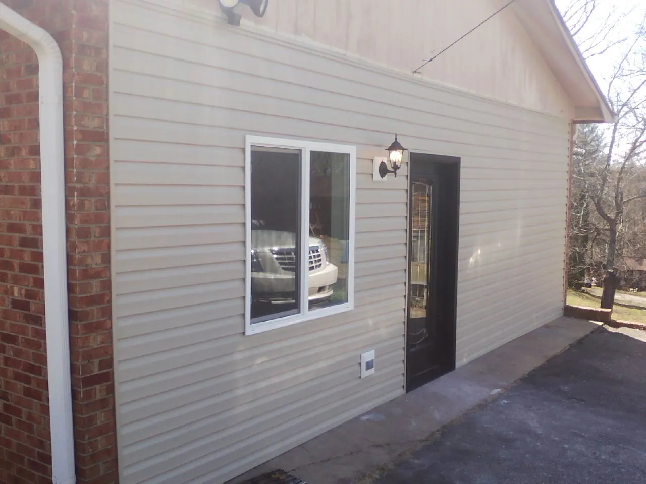 New vinyl siding and entry door on a room addition in Solomon